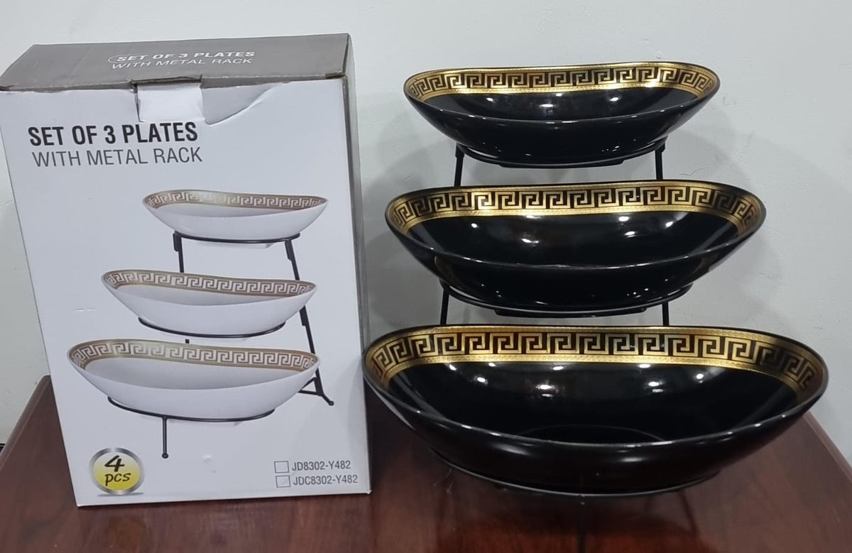 set of 3 ceramic fruit plates on black metal rack
