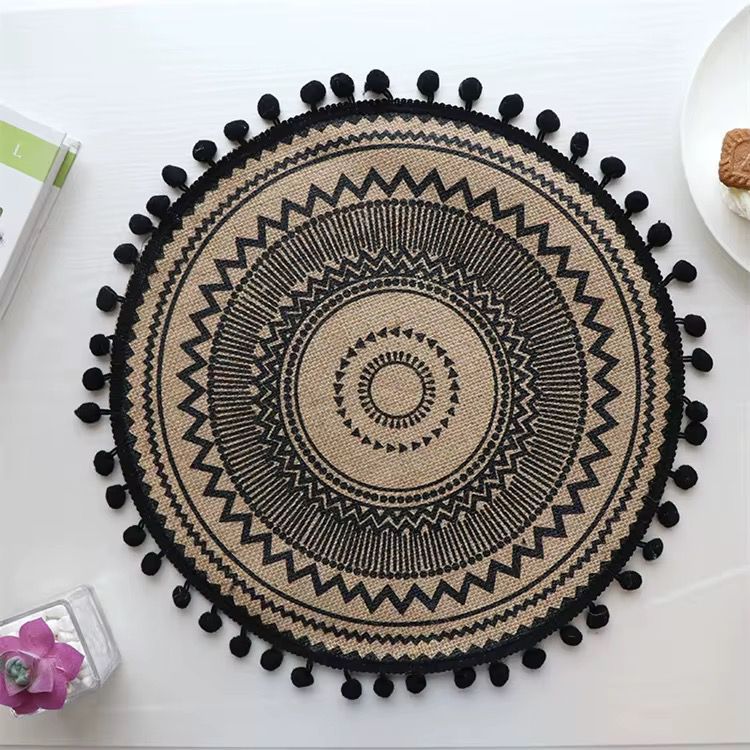 Beautiful round woven table mat with lace detail and pom-pom edges